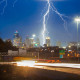 lightning above kansas city skyline with highway traffic motion