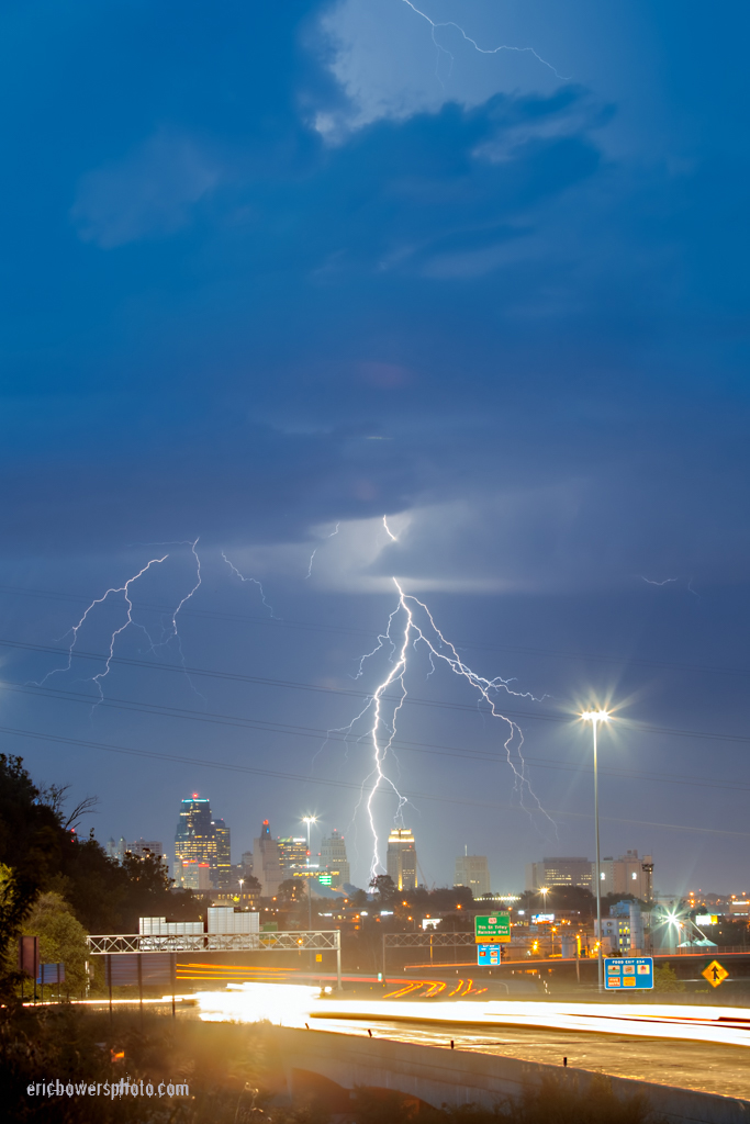 lightning above kansas city skyline with highway traffic motion