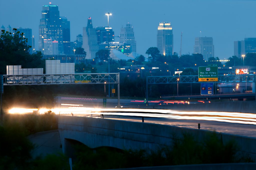city skyline with traffic motion light trails