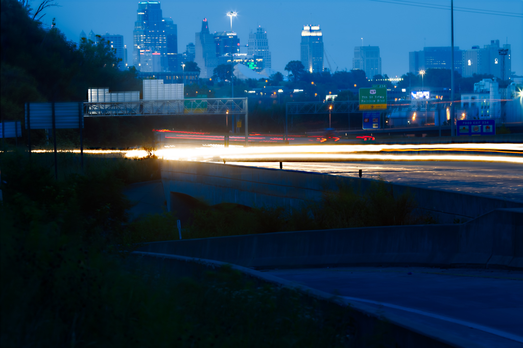 city skyline with traffic motion light trails
