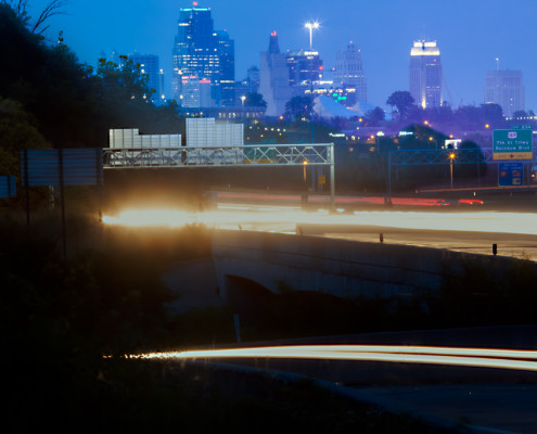 city skyline with traffic motion light trails